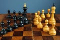 Leader vs boss or manager. Chess kings and pawns on desk