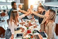 We are leaders on the market. Cheerful young people giving each other high-five with smile while sitting at the office table on Royalty Free Stock Photo