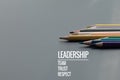 Leadership business concept. Gold color pencil lead other color with word Leadership, team, trust and respect on black background Royalty Free Stock Photo
