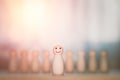 Leadership and business concept. The wooden figure smile and stands in front of teams. Succesful competition, winner, creative and Royalty Free Stock Photo