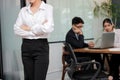 Leadership business woman concept. Cropped image of young Asian businesswoman standing against her colleague in office background Royalty Free Stock Photo