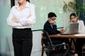 Leadership business woman concept. Cropped image of young Asian businesswoman standing against her colleague in office background. Royalty Free Stock Photo