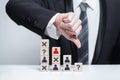 Leadership, carieer, team business concept, businessman thumb down. Wooden blocks with people icons Royalty Free Stock Photo