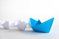 Leadership concept. blue paper ship lead among white. Royalty Free Stock Photo