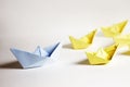 Leadership concept. Paper boats on a white background. Royalty Free Stock Photo