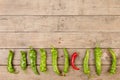 Leadership concept - red hot chili pepper leading the group of green ones Royalty Free Stock Photo