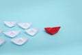 Leadership concept. Red leader paper ship leading among white on blue background Royalty Free Stock Photo