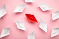 Leadership concept. Red leader paper ship leading among white on pink background Royalty Free Stock Photo