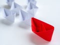 Leadership concept. Red paper ship lead among white. One leader Royalty Free Stock Photo