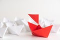 Leadership concept. red paper ship lead among white. One leader Royalty Free Stock Photo