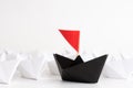 Leadership concept. red paper ship lead among white. One leader Royalty Free Stock Photo