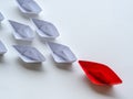 Leadership concept. Red paper ship lead among white. One leader Royalty Free Stock Photo