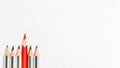 Leadership concept. Red pencil standing out from crowd of black pencils. Royalty Free Stock Photo