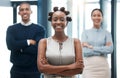 Leadership, female empowerment and proud business woman standing with her team and smiling with her arms crossed Royalty Free Stock Photo