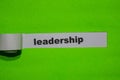 Leadership, inspiration concept on green torn paper