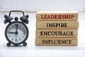 Leadership, inspire, encourage, influence text on wooden blocks with white cover background. Leadership concept.