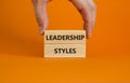 Leadership styles symbol. Wooden blocks with words `Leadership styles` on beautiful orange background. Businessman hand. Busines Royalty Free Stock Photo