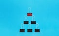 Leadership, teamwork, unique and business concept. Office supplies, red binder paper clip over black binder clips Royalty Free Stock Photo