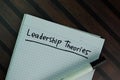 Leadership Theories write on a book isolated on Wooden Table