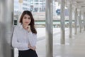 Leadership young Asian businesswoman standing and looking to camera at walkway of outside office