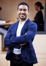 Leading the business to success. a handsome young businessman standing in the office with his arms folded. Royalty Free Stock Photo