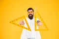 Leading engineer of the project. Smart engineer holding triangles on yellow background. Teaching engineer smiling with Royalty Free Stock Photo