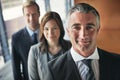 Leading his team with an expanse of experience. Portrait of a team of professionals standing together in an office. Royalty Free Stock Photo