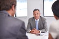 Leading his team to success. a mature businessman in a meeting with his employees. Royalty Free Stock Photo