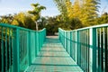 Leading lines of blue footbridge railing and path crossing valley
