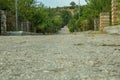 Leading old rough road in a caucasus village Royalty Free Stock Photo