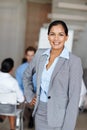 She leads by example. A confident businesswoman with her hand on her hip. Royalty Free Stock Photo