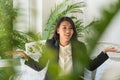 The leaf blurred in front of beautiful young business woman raised her hand shrug her shoulders