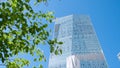 A leaf and building. Stock. Modern office building through the leaves of a tree. Business and nature concept