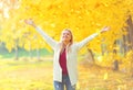 Leaf fall, happy expression young woman having fun in warm sunny autumn Royalty Free Stock Photo