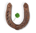 Horseshoe and a four-leaf clover with drawn leaf Royalty Free Stock Photo