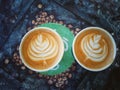 Leaf pattern texture on cup of coffee in a coffee shop.