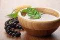 Leaf in wooden bowl and beads. zen background