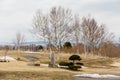 Leafless trees with brown grass on the land near Lake Toya in winter in Hokkaido, Japan Royalty Free Stock Photo