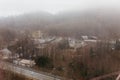 Leafless trees with mountain and carpark in the fog that view from the top in Usuzan Ropeway at Mount Usu in winter in Hokkaido