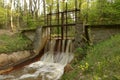 Old weir on a small river that runs through the forest. Royalty Free Stock Photo