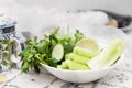 Leafy green salad, celery and cucumber on white bowl as a symbol of healthy food