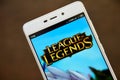 LEAGUE OF LEGENDS logo seen on the smartphone screen