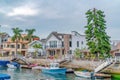 Leaisure boats docked on canal in Long Beach neighborhood with resort like views Royalty Free Stock Photo