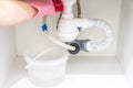 Leakage Of Water From plastic Pipe under sink in laundry room Royalty Free Stock Photo