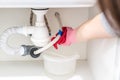 Leakage Of Water From plastic Pipe under sink in laundry room Royalty Free Stock Photo