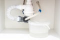 Leakage Of Water From plastic Pipe under sink in laundry room Royalty Free Stock Photo