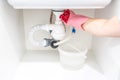 Leakage Of Water From plastic Pipe under sink in laundry room Royalty Free Stock Photo