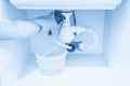 Leakage Of Water From plastic Pipe under sink in laundry room Royalty Free Stock Photo