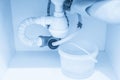 Leakage Of Water From plastic Pipe under sink in laundry room Royalty Free Stock Photo