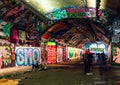 London, UK/Europe; 21/12/2019: Leake Street, underground tunnel with graffiti covered walls in London. Scene with pedestrians and Royalty Free Stock Photo